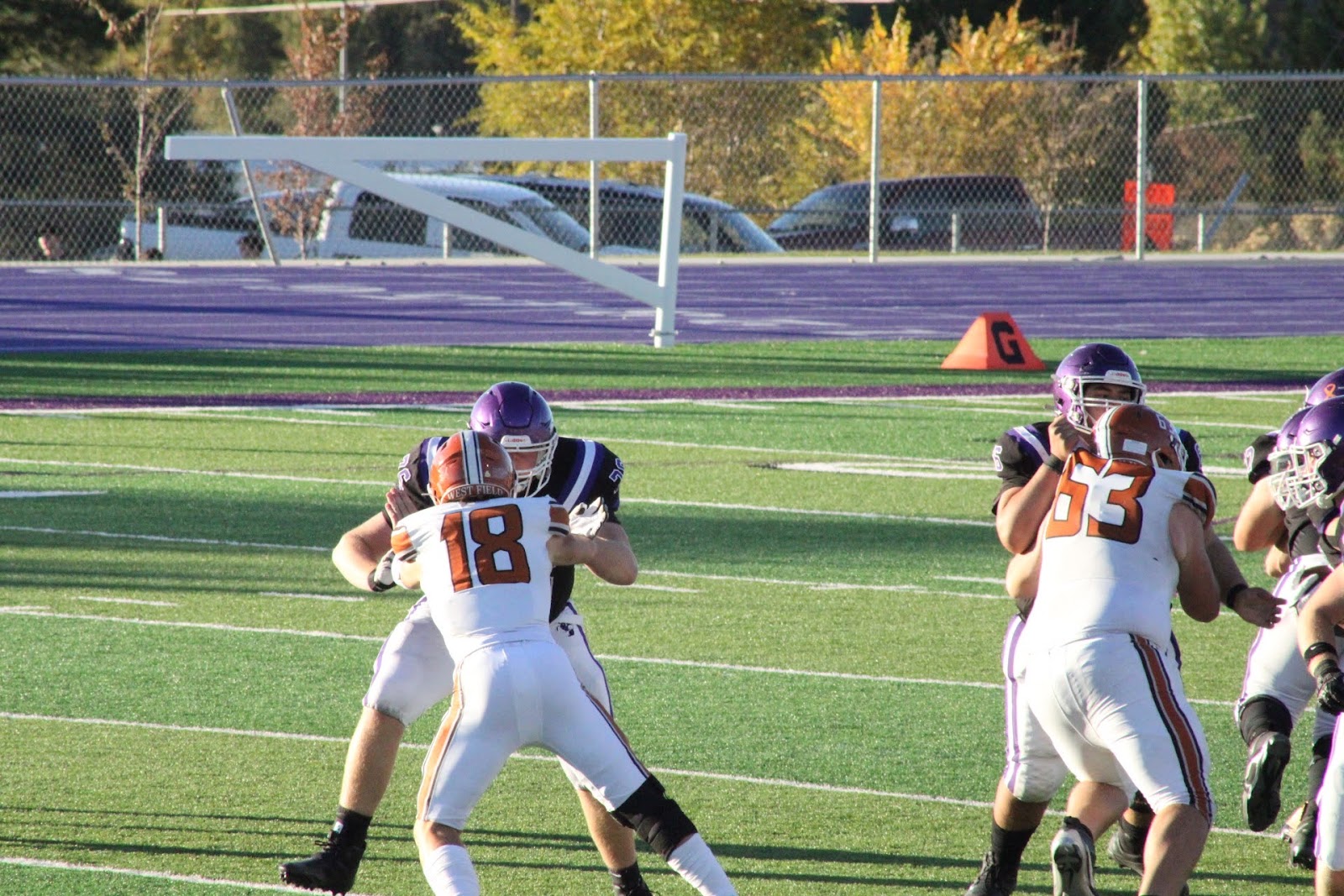 Football player number 18 running down the sideline with the ball